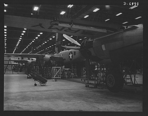 Production. B-25 bombers. They'll soon be ready to hurl their might at the Axis. New B-25 medium bombers nearing the end of a Western aircraft assembly line. General Doolittle calls it the best military plane in existence. Fairfax bomber plant, Kansas City