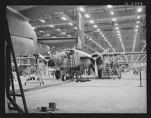 Production. B-25 bombers. They'll soon be ready to hurl their might at the Axis. New B-25 medium bombers nearing the end of a Western aircraft assembly line. General Doolittle calls it the best military plane in existence. Fairfax bomber plant, Kansas City