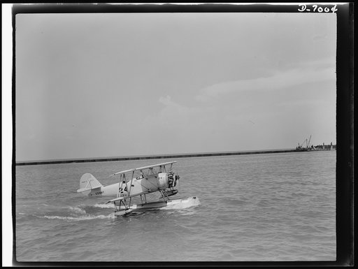 Naval air base, Corpus Christi, Texas. Skimming across the water in a perfect landing, a Navy training ship M2M, approaches the naval air base in Corpus Christi, Texas. This is a type of plane used for training cadets at the base