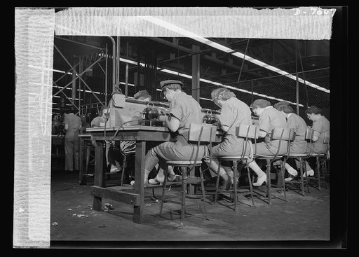 Women in war. Supercharger plant workers. These women war workers at a Midwest supercharger plant are buffing small delicate airplane engine parts. Note protective head coverings and comfortable slack suits. Allis Chalmers Manufacture Company