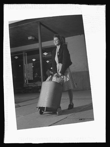 I'll carry mine. A boon for wartime shoppers, this cart is one of the various carry alls which have been devised to help Mrs. America get purchases home, now that truck deliveries are limited