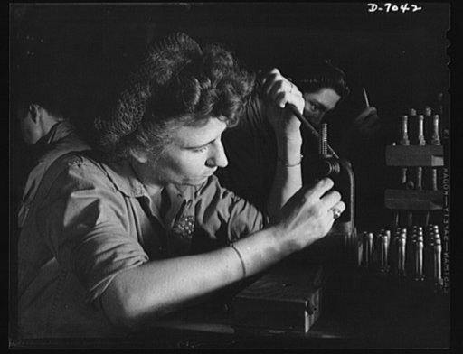 Naval air base, Corpus Christi, Texas. A Navy wife works to keep HIM flying. She has been trained to recondition spark plugs in the assembly and repair department of the Corpus Christi, Texas, naval air base. Her job is under civil service