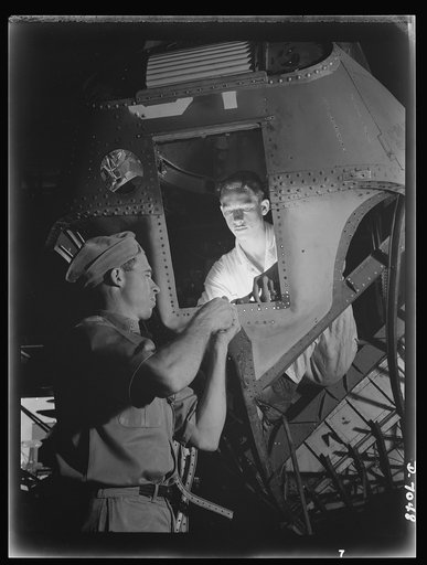 Naval air base, Corpus Christi, Texas. Navy planes must be mechanically perfect. Lloyd H. Brooknole (left), an experience sheet metal worker, repairs and assembles planes at the naval air base in Corpus Christi, Texas. A helper, Elmer J. Pace, is getting practical experience working with Brooknole. 