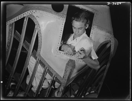 Naval air base, Corpus Christi, Texas. Working inside the nose of a PBY, Elmer J. Pace is learning the construction of Navy planes. As an National Youth Administration (NYA) trainee, Elmer gets practical experience at the Corpus Christi naval air base in Texas. After about eight weeks, he will go in