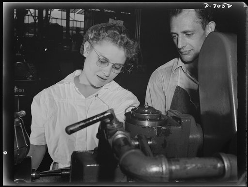 Naval air base, Corpus Christi, Texas. Learning to fight the Axis with an electric lathe. Mabel Carmen left her home in Mississippi to join the National Youth Administration (NYA) group at the naval air base in Corpus Christi, Texas. After receiving eight weeks training under Donald Bantert (right),