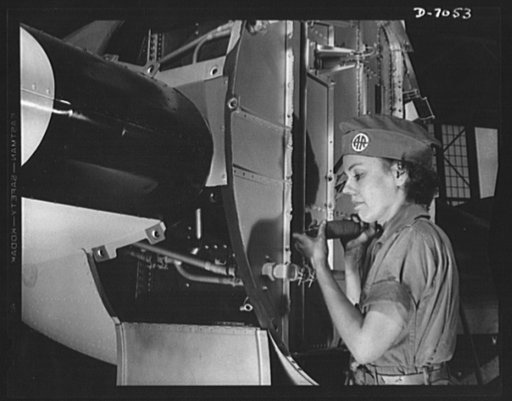 Naval air base, Corpus Christi, Texas. There's a war to be won, and Miss Mildred Hanna is helping to win it. After Pearl Harbor, Miss Hanna left school teaching and went to the ssembly and repair department of the naval air base at Corpus Christi, Texas. Here she is working on the firewall of a PBY 