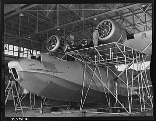 Naval air base, Corpus Christi, Texas. The pilots fly it, but the ground crew keeps it flying. Every ship, after so many hours in the air must be completely reconditioned. Here, in a hanger of the naval air base at Corpus Christi, Texas, women Civil Service workers of the assembly and repair departm
