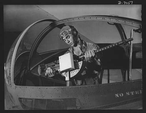 Naval air base, Corpus Christi, Texas. It's an intricate operation installing a 30-caliber machine gun in a Navy PBY plane, but not too tricky for Jesse Rhodes Waller. He's a Georgia man who's been in the Navy five and a half years. At the naval air base in Corpus Christi, Texas, he sees that flying