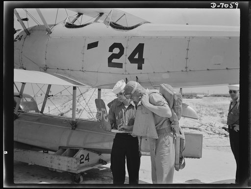 Naval air base, Corpus Christi, Texas. Signing out before taking off. Before each flight, at the naval air base in Corpus Christi, Texas, the yellow flight sheet records are kept at the base. Servicing of the planes is done by sailor mechanics attached to the base