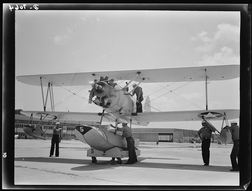 Naval air base, Corpus Christi, Texas. Last minute check-up is made by a sailor at the naval air base in Corpus Christi, Texas, before the N3N, a primary training sea plane, is launched