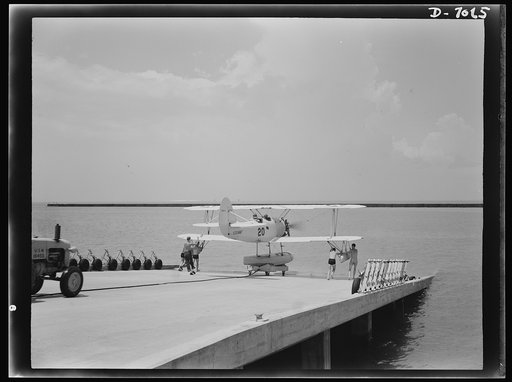 Naval air base, Corpus Christi, Texas. Ready to soar out over the water, this N3N training plane coasts down the plank to launching. Cadets at the naval air base in Corpus Christi, Texas, are trained in planes carefully conditioned by sailor mechanics at the base