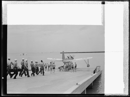 Naval air base, Corpus Christi, Texas. The powerful airship slides down the gangplank, hits the water, and the launching is completed. This is the Kingfisher Service type plane, technically termed the OS2-U3