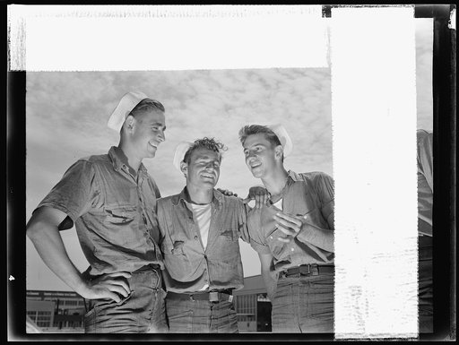 Naval air base, Corpus Christi, Texas. "And so he says to me...." sailor mechanics at the naval air base in Corpus Christi, Texas, laugh heartily over a good story between servicing operations on Navy planes