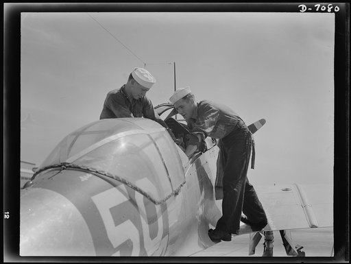 Naval air base, Corpus Christi, Texas. Sailors stationed at the naval air base in Corpus Christi, Texas, check the pilot seat of an SNC advance training plane