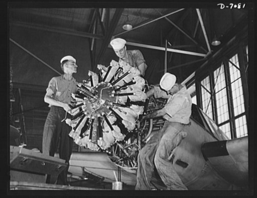 Naval air base, Corpus Christi, Texas. Reconditioning the motors of airplane at the Corpus Christi, Texas, naval air base is being done here by three aviation mechanics mates stationed at the base