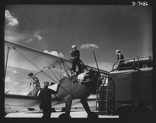 Naval air base, Corpus Christi, Texas. Feuling an N2S, primary land plane, at the naval air base in Corpus Christi, Texas. Sailor mechanics at the base service the ship as a cadet prepares for the take-off