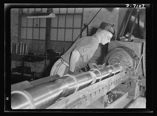 Production. 105 millimeter shells. Plumbing fixtures came off these assembly lines in peace time, but today Giles Knowles and his fellow workers produce 105 millimeter shells in a Midwest plant now converted 100 percent to war production. Knowles, a minor league baseball pitcher, broke a league reco
