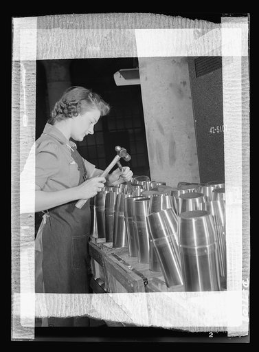 Production. 105 millimeter shells. One of the many women workers in a Midwest shell plant which formerly made plumbing fixtures, inspects future gifts for the Axis. Her job requires infinite precision and patience, for the inside of every shell must be carefully inspected for flaws which might accid