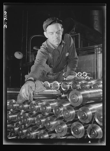 Production. 105 millimeter shells. Carefully stacked prior to shipment, thousands of shining shells await shipment to the fighting fronts. These 105 millimeter shells were made in a Midwest plant, where plumbing fixtures were manufactured in peace time (Manitowac Shipyards)