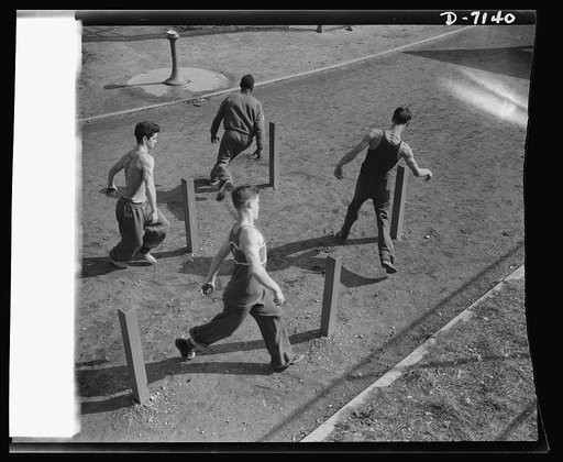 High school Victory Corps. Boys at Flushing High School, Queens, New York, toughen up by methods similiar to those used in Commando training. Ability to cover distances quickly despite obstacles is developed by the school's ranger course which these boys are enrolled in
