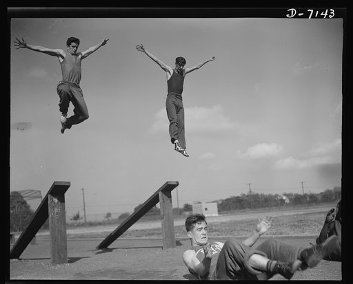 High school Victory Corps. By the time these boys are old enough to join America's fighting forces they will be toughened to commando standards. Flushing High School, Queens, New York, has expanded its physical education activities to include the type of training made necessary by wartime