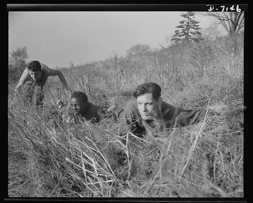 High school Victory Corps. Learning the rudiments of advancing on an enemy will prove valuable to these boys if they are called to join their older brothers in the armed forces. This is part of the "commando" training given in physical education courses at Flushing High School, Queens, New York