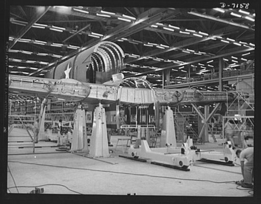 Production. B-24 bombers and C-87 transports. The tail of a consolidated transport plane is fitted to the wing center section in the fuselage mating fixture at a Western aircraft plant. This new transport, an adaptation of the B-24 bomber, is known as the C-87, and carries one of the greatest human 
