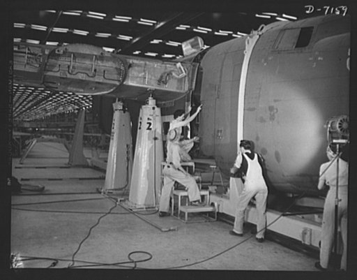Production. B-24 bombers and C-87 transports. The nose section of a mighty consolidated transport plane, goes into place in the fuselage mating fixture of a Western aircraft plant. This new transport, an adaptation of the B-24 bomber, is known as the C-87, and carries one of the greatest human or ca