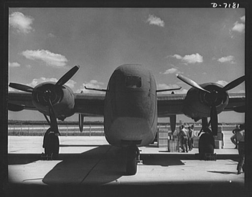 Production. B-24 bombers and C-87 transports. A new consolidated transport, just off the assembly line of a Western aircraft plant are loaded with cargo. The site of the plant and flying field was a cow pasture not so long before Pearl Harbor. This new transport, an adaptation of the B-24 bomber, is