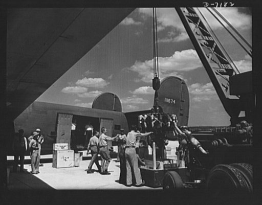 Production. B-24 bombers and C-87 transports. A new consolidated transport, just off the assembly line of a Western aircraft plant are loaded with cargo. The site of the plant and flying field was a cow pasture not so long before Pearl Harbor. This new transport, an adaptation of the B-24 bomber, is