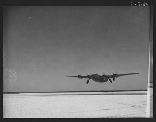 Production. B-24 bombers and C-87 transports. Maiden flight for a new consolidated transport, just off the assembly line of a Western plant. Wheels are being retracted just after the takeoff. This new warship of the air is capable of operation at high altitudes and over great ranges for high accurac