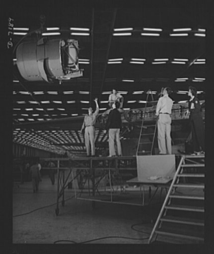 Production. B-24 bombers and C-87 transports. Lowering one of the four engines of a mighty consolidated transport plane at a Western aircraft plant. This new transport, an adaptation of the B-24, which is known as the C-87, and carries one of the greatest human or cargo loads of any plane now in mas