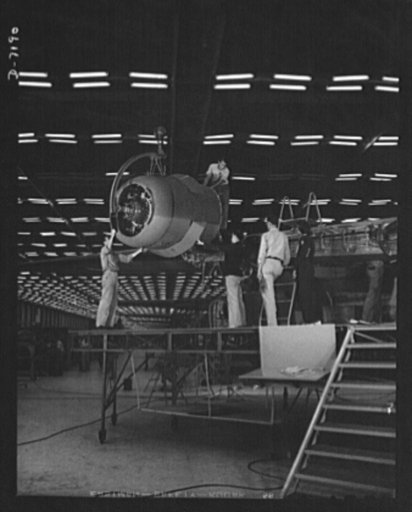 Production. B-24 bombers and C-87 transports. Lowering one of the four engines of a mighty consolidated transport plane at a Western aircraft plant. This new transport, an adaptation of the B-24, which is known as the C-87, and carries one of the greatest human or cargo loads of any plane now in mas