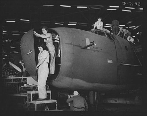 Production. B-24 bombers and C-87 transports. Installing the nose door of a consolidated transport plane, one of the last assembly line operations at a Western aircraft plant. Here womanpower and manpower work together or various sections of the plane. This new transport, an adaptation of the B-24 g