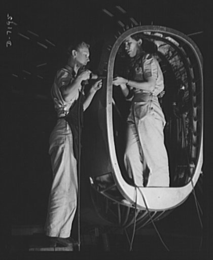 Production. B-24 bombers and C-87 transports. A two-girl riveting crew putting the skin on a nose extension of a big consolidated transport plane in a Western plant. The riveter working from the outside was a home girl before she took up war work. The helper, bucking the rivets from the inside of th