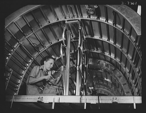 Production. B-24 bombers and C-87 transports. Cabbie Coleman, former housewife, works in a Western aircraft plant installing oxygen flask racks above the flight deck of a consolidated transport. This ship, adapted from the B-24 bomber, is known as the C-87, and carries one of the greatest human or c
