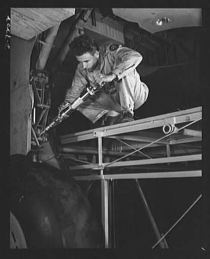 Production. B-24 bombers and C-87 transports. Hydraulic mechanic at a  Western aircraft plant greasing the landing gear of a consolidated transport, just before the plane leaves the last station on the assembly line. This new transport, adapted from the B-24 bomber is known as the C-87, and carries 