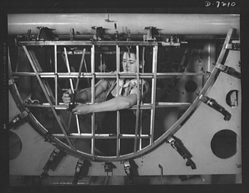 Production. B-24 bombers and C-87 transports.  Helen Bray, who left school to become a mechanic at a Western aircraft plant, is making an emplanage section on a new consolidated transport. This new ship adapted from the B-24 bomber, is known as the C-87, carries one of the greatest human or cargo lo