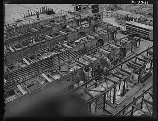 Production. B-24 bombers and C-87 transports. Center wing sections at a Western aircraft plant now producing consolidated B-24 bombers and transports. The new transport ship, an adaptation of the B-24 bomber, is known as the C-87, and carries one of the greatest human or cargo loads of any plane now