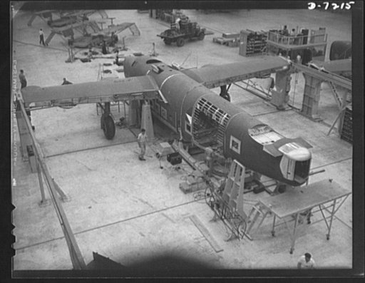 Production. B-24 bombers and C-87 transports. A mating operation on a consolidated transport plane just before it comes to the pre-assembly line. This transport, an adaptation of the B-24 bomber, is known as the C-87, and carries one of the greatest human and cargo load than any other plane now in m