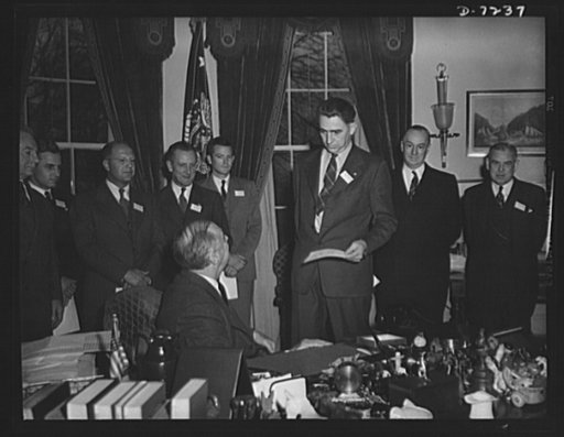 Citation winners. President Roosevelt, speaking with Daniel W. Mallett an employee at Mechanics Universal Joint Division, Borg-Warner Corporation, Rockford, Illinois, after presenting him a certificate