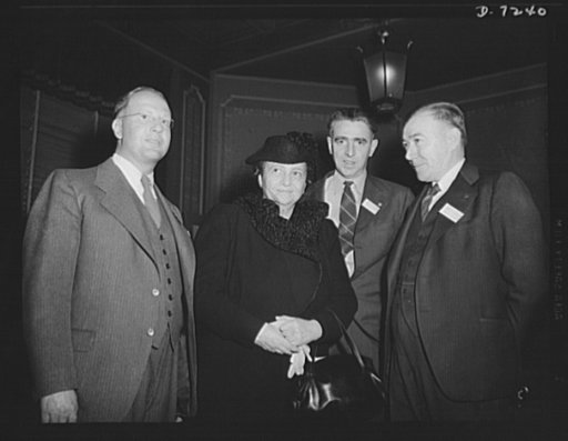 Citation winners. Secretary of Labor Frances Perkins, with a trio of workers at the luncheon tendered by Donald M. Nelson, Chairman of the War Production Board (WPB), following the White House ceremony, left to right; Clinton R. Hanna, citation winner, Westinghouse Electric and Manufacturing Company