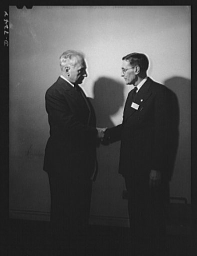 Citation winners. Joseph H. Kautsky, (right) an employee at the Dodge Plant of the Link-Belt Company of Indianapolis, Indiana is shown being congratulated by William G. Marshall, director of the war production drive, who presented the workers to President Roosevelt