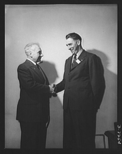 Citation winners. Citation winner, Daniel Walter Mallett, of the Mechanics Universal Joint Division, Borg-Warner Corporation, Rockford, Illinois receives congratulations from William G. Marshall (left), Director of the War Production Drive, who presented the workers to President Roosevelt