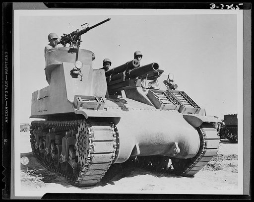 The M-7 is the Army's newest tank destroyer and is really a "killer." Being tested for desert warfare at Iron Mountains, California. It carries both a 105mm Howitzer and a 50 caliber gun. Lieutenant M. Hutchison of Enterprise, Alabama is at the extreme right. Corporal L. Roberts from Graham, Texas i