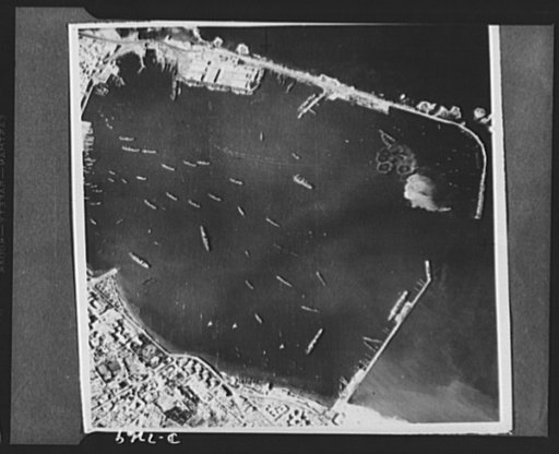 U.S. Air Force bombs Tripoli. U.S. Army bombers made their first raid on Tripoli recently and returned with this unusal series of pictures showing the results of the raid. Their objective was the Spanish mole at upper left and they were not aiming at ships in the harbor. This photo first in the seri