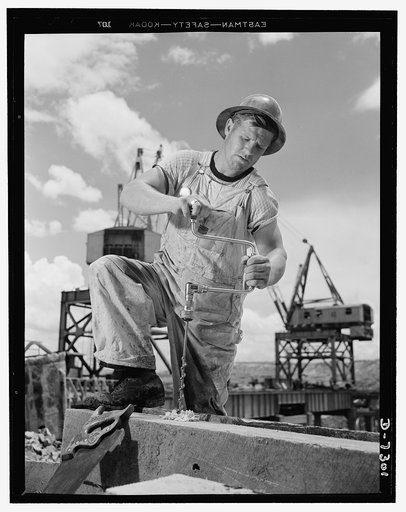 Tennessee Valley Authority. Construction of Douglas Dam. A carpenter at the TVA's new Douglas Dam on the French Broad River. This dam will be 161 feet high and 1,682 feet long, with a 31,600 acre reservoir area extending forty-three miles upstream. With a useful storage capacity of approximately 1,3