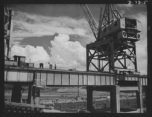 Tennessee Valley Authority. Construction of Douglas Dam. Riggers bust at work on TVA's new Douglas Dam on the French Broad River. This dam will be 161 feet high and 1,682 feet long, with a 31,600 acre reservoir area extending forty-three miles upstream. With a useful storage capacity of approximatel