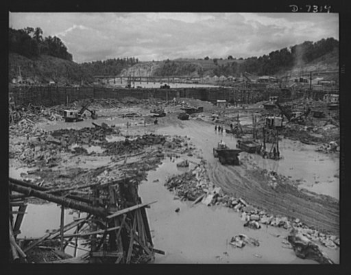 Tennessee Valley Authority. Construction of Douglas Dam. Excavating within the cofferdam of TVA's new Douglas Dam on the French Broad River. This dam will be 161 feet high and 1,682 feet long, with a 31,600 acre reservoir area extending forty-three miles upstream. With a useful storage capacity of a