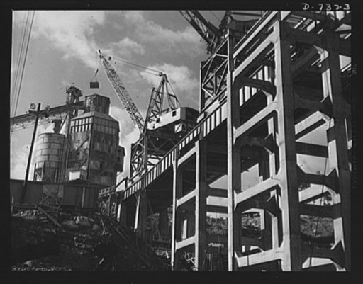 Tennessee Valley Authority. Construction of Douglas Dam. A concrete mixer and the crane that serve it, at TVA's new Douglas Dam on the French Broad River. This dam will be 161 feet high and 1,682 feet long, with a 31,600 acre reservoir area extending forty-three miles upstream. With a useful storage